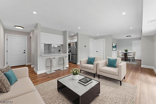 20 Beaconsfield Pl, Franklin Twp, NJ 08873 - living area featuring light wood finished floors, baseboards, and recessed lighting