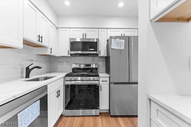 20 Beaconsfield Pl, Franklin Twp, NJ 08873 - kitchen with appliances with stainless steel finishes, a sink, white cabinetry, recessed lighting, and tasteful backsplash