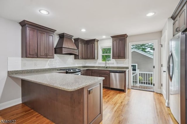 49 Summit Ave Unit B, Chatham Boro, NJ 07928 - kitchen with stainless steel appliances, premium range hood, a peninsula, backsplash, and light wood finished floors