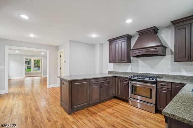 49 Summit Ave Unit B, Chatham Boro, NJ 07928 - kitchen featuring premium range hood, stainless steel gas range oven, light wood-style flooring, backsplash, and dark brown cabinets