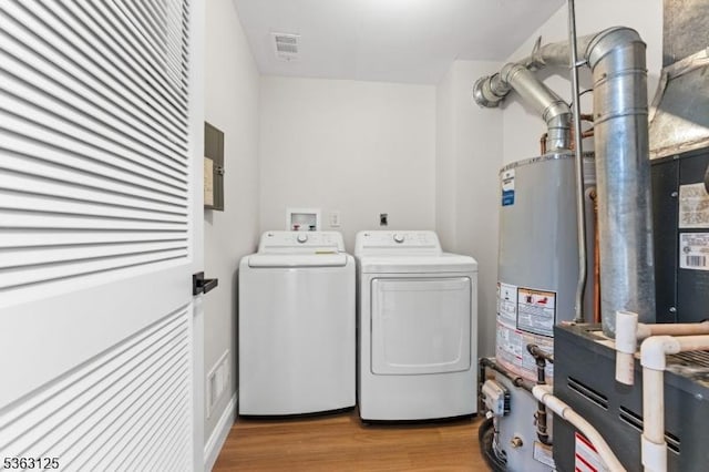 35 Amethyst Way, Franklin Twp, NJ 08823 - washroom with washing machine and dryer, light wood-style floors, and water heater