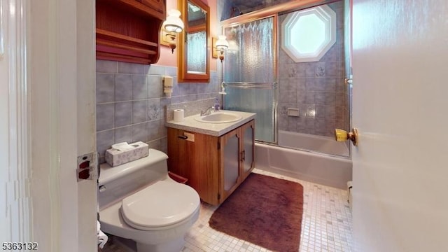 2039 Church Ave, Scotch Plains Twp, NJ 07076 - bathroom featuring vanity, toilet, bath / shower combo with glass door, tile walls, and tile patterned floors
