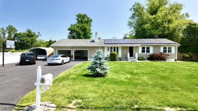 151 2nd St, Franklin Twp, NJ 08873 - ranch-style home with driveway, a carport, an attached garage, roof mounted solar panels, and a chimney