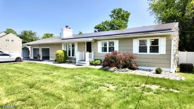 151 2nd St, Franklin Twp, NJ 08873 - view of front facade with a garage, solar panels, a front yard, a chimney, and cooling unit
