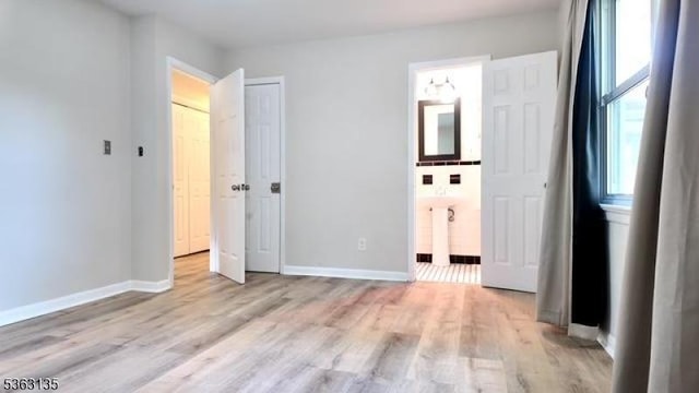 151 2nd St, Franklin Twp, NJ 08873 - unfurnished bedroom featuring light wood-style floors, baseboards, and ensuite bath