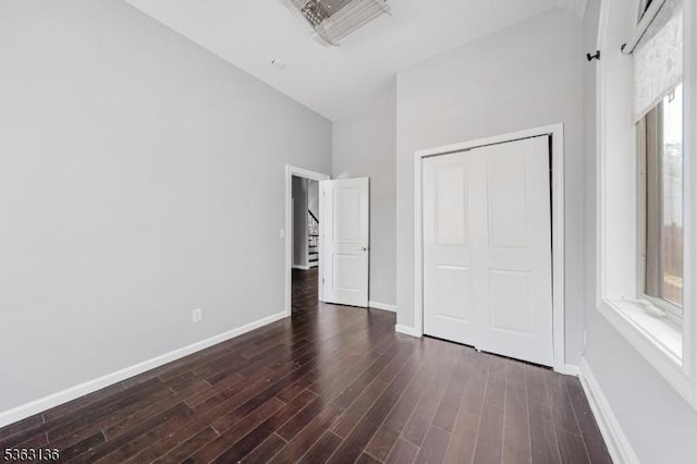 69 Summit Rd, Elizabeth City, NJ 07208 - unfurnished bedroom with high vaulted ceiling, dark wood finished floors, baseboards, and a closet