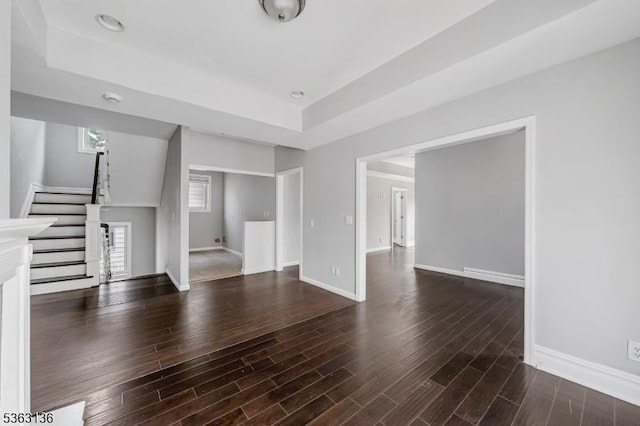 69 Summit Rd, Elizabeth City, NJ 07208 - unfurnished living room with a tray ceiling, stairs, wood finished floors, and baseboards
