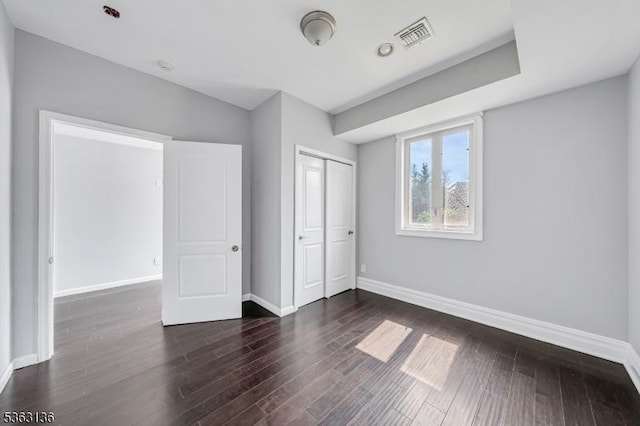 69 Summit Rd, Elizabeth City, NJ 07208 - unfurnished bedroom with baseboards, dark wood finished floors, and a closet