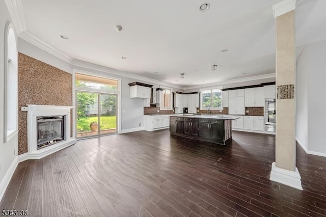 69 Summit Rd, Elizabeth City, NJ 07208 - living room with baseboards, dark wood-style flooring, crown molding, a glass covered fireplace, and recessed lighting