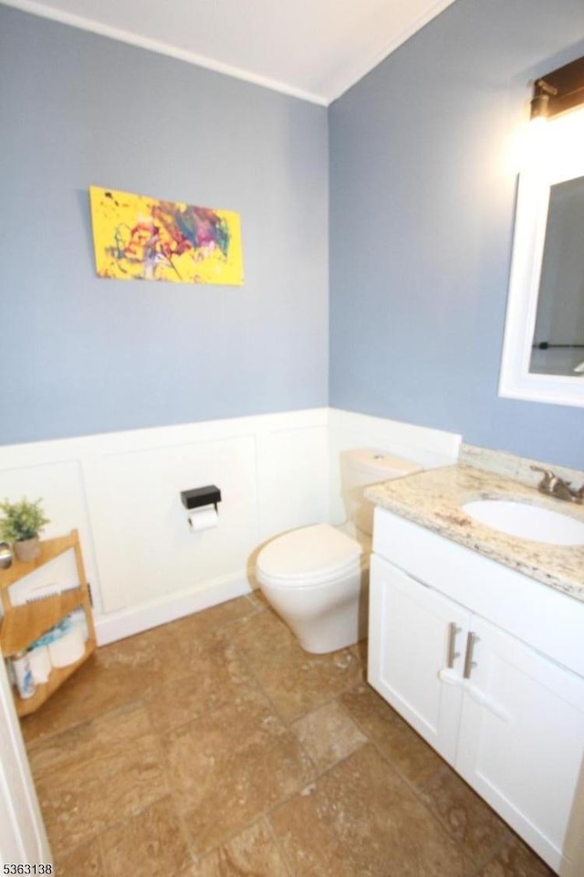 132 Sloop Rd, Stafford Twp, NJ 08050 - bathroom with vanity, toilet, ornamental molding, wainscoting, and a decorative wall