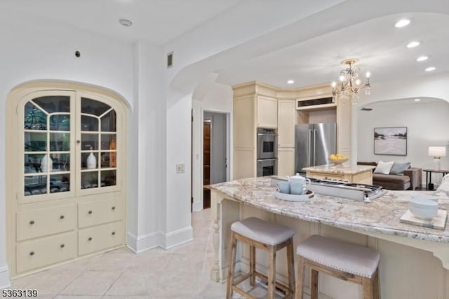 460 Overhill Rd, South Orange Village Twp, NJ 07079 - kitchen with appliances with stainless steel finishes, arched walkways, a kitchen breakfast bar, light stone counters, and recessed lighting