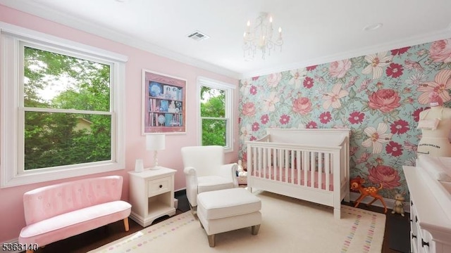 120 Cottage Pl, Westfield Town, NJ 07090 - bedroom with wallpapered walls, multiple windows, ornamental molding, wood finished floors, and a crib