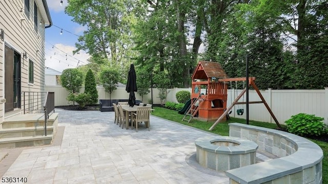 120 Cottage Pl, Westfield Town, NJ 07090 - fenced backyard with a patio area, outdoor dining space, a playground, and an outdoor fire pit