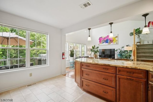 157 Rock Rd, Wayne Twp, NJ 07470 - kitchen with plenty of natural light, light stone countertops, light tile patterned flooring, and decorative light fixtures