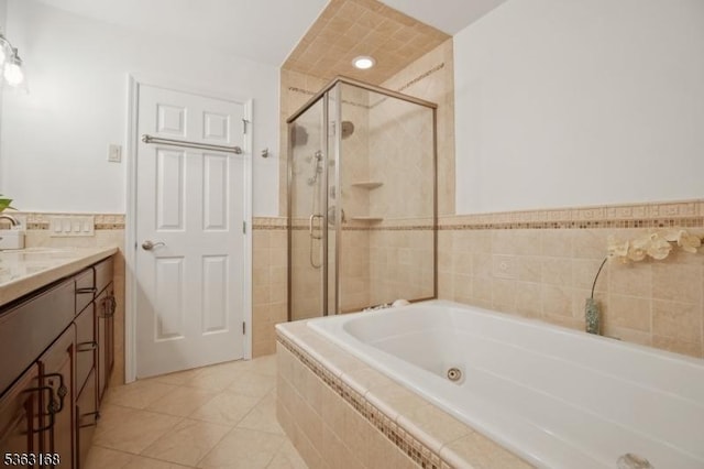 157 Rock Rd, Wayne Twp, NJ 07470 - bathroom featuring tile walls, a stall shower, a tub with jets, vanity, and tile patterned flooring