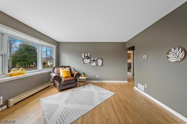 304 Lilac Ct, Bridgewater Twp, NJ 08807 - living area with a baseboard radiator, light wood-style flooring, and baseboards