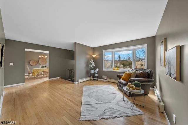304 Lilac Ct, Bridgewater Twp, NJ 08807 - living area featuring a baseboard radiator, light wood-style floors, and baseboards