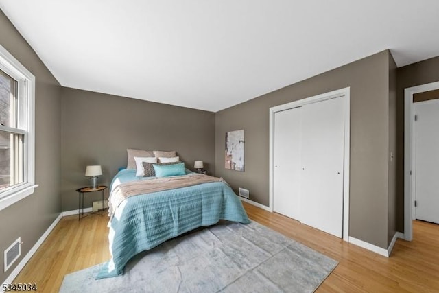 304 Lilac Ct, Bridgewater Twp, NJ 08807 - bedroom with wood finished floors, a closet, and baseboards