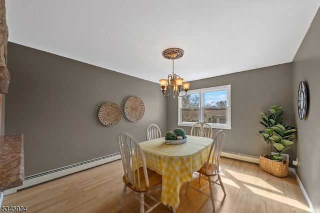 304 Lilac Ct, Bridgewater Twp, NJ 08807 - dining area featuring baseboard heating, light wood-type flooring, a chandelier, and baseboards