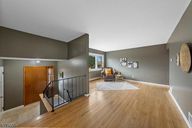 304 Lilac Ct, Bridgewater Twp, NJ 08807 - sitting room featuring an upstairs landing, light wood finished floors, a baseboard heating unit, and baseboards