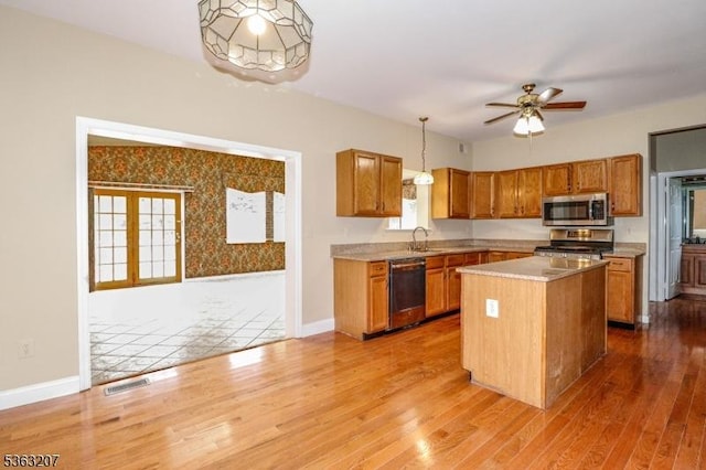 8 Staudt Ct, Franklin Twp, NJ 08873 - kitchen with appliances with stainless steel finishes, wood finished floors, brown cabinets, and light countertops