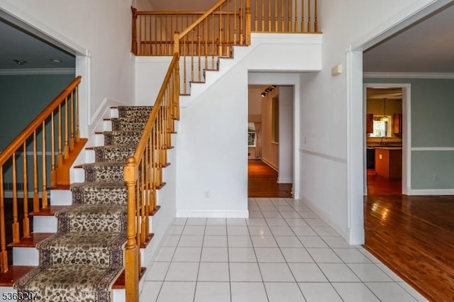 8 Staudt Ct, Franklin Twp, NJ 08873 - staircase featuring crown molding, a towering ceiling, baseboards, and tile patterned floors
