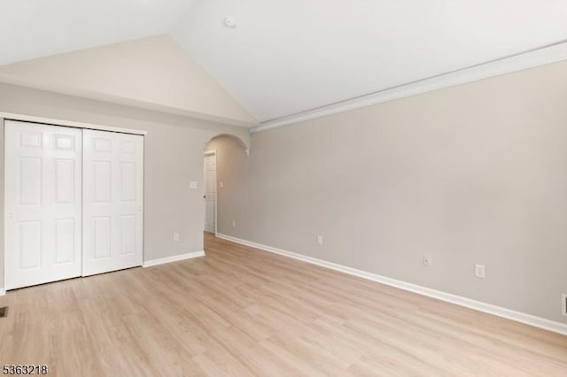 133 Marlboro Cir, Lopatcong Twp, NJ 08886 - unfurnished bedroom featuring arched walkways, lofted ceiling, light wood-type flooring, a closet, and baseboards