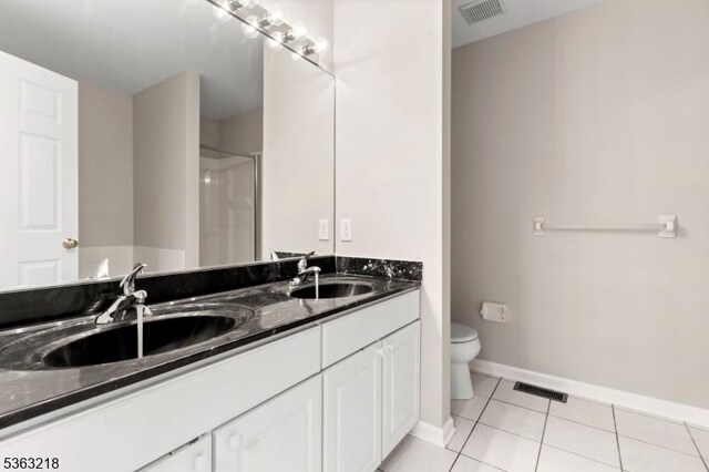 133 Marlboro Cir, Lopatcong Twp, NJ 08886 - bathroom featuring toilet, double vanity, tile patterned floors, baseboards, and a shower with shower door