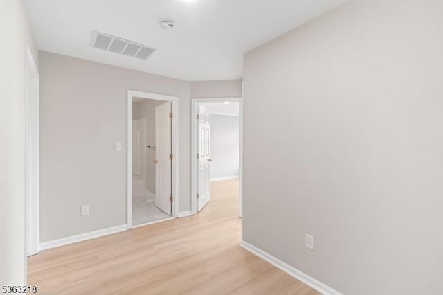 133 Marlboro Cir, Lopatcong Twp, NJ 08886 - unfurnished bedroom with light wood-type flooring, baseboards, and connected bathroom