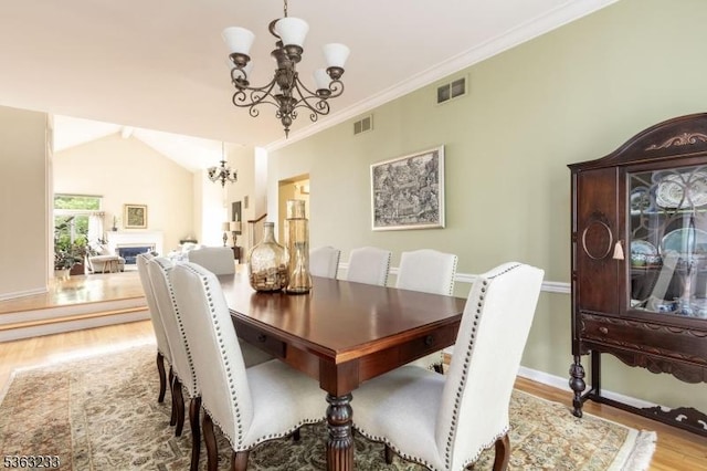21 Stafford Ln, Bedminster Twp, NJ 07921 - dining space with a chandelier, wood finished floors, baseboards, a fireplace, and crown molding