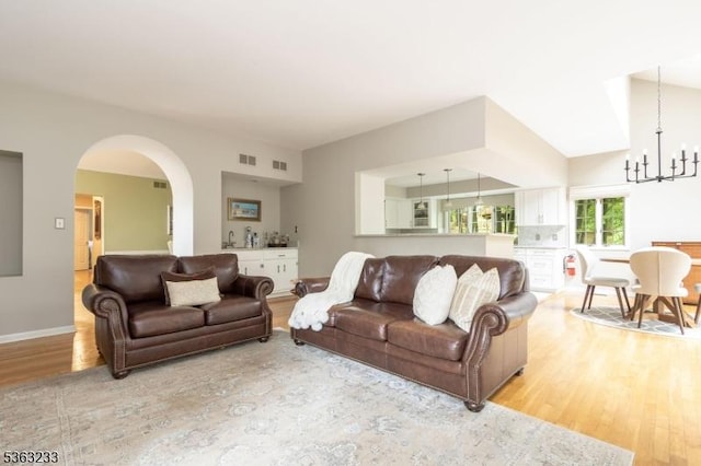 21 Stafford Ln, Bedminster Twp, NJ 07921 - living area with light wood finished floors, a chandelier, arched walkways, and baseboards