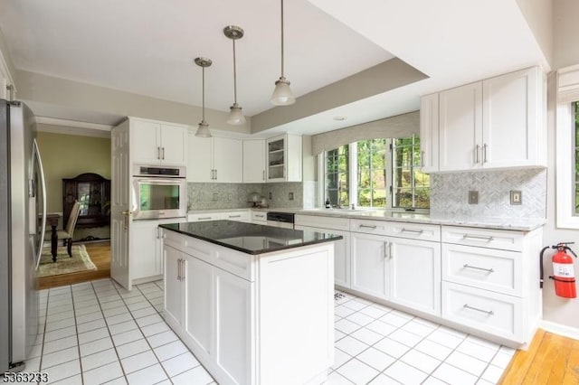 21 Stafford Ln, Bedminster Twp, NJ 07921 - kitchen featuring appliances with stainless steel finishes, backsplash, and white cabinetry