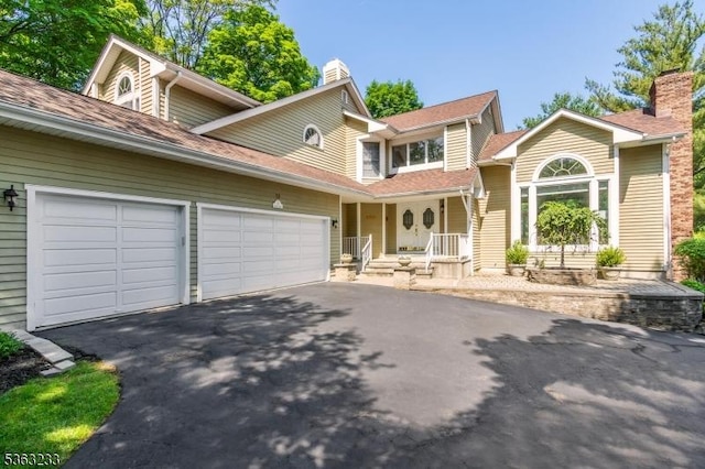 21 Stafford Ln, Bedminster Twp, NJ 07921 - view of front of home featuring a garage, asphalt driveway, and a chimney