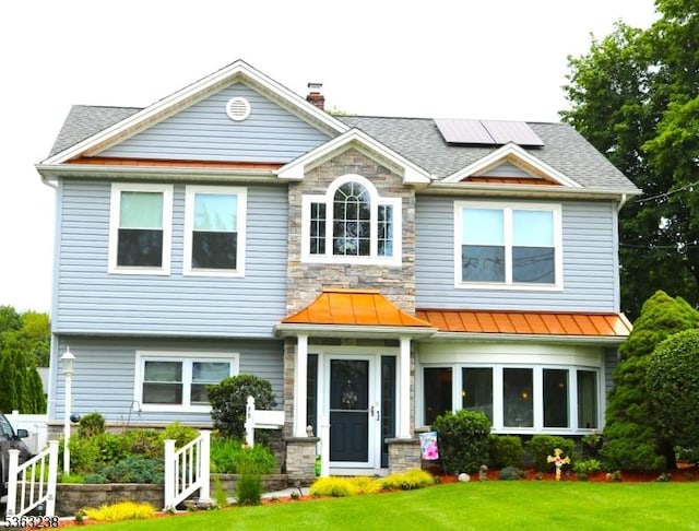 75 Sunrise Ter, Cedar Grove Twp, NJ 07009 - view of front of house featuring roof mounted solar panels, a standing seam roof, a front yard, roof with shingles, and metal roof