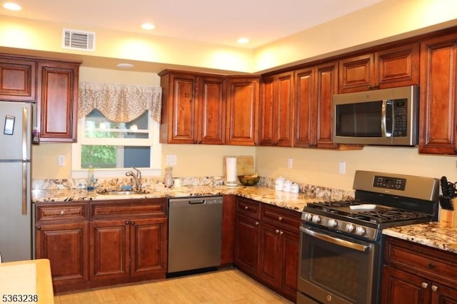 75 Sunrise Ter, Cedar Grove Twp, NJ 07009 - kitchen with stainless steel appliances, a sink, light stone counters, light wood-style flooring, and recessed lighting