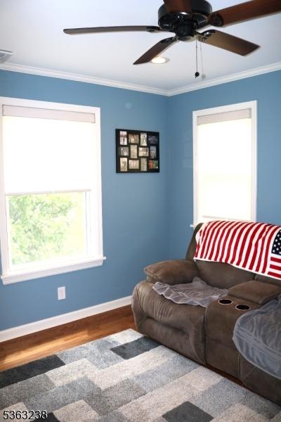 75 Sunrise Ter, Cedar Grove Twp, NJ 07009 - living area featuring wood finished floors, ornamental molding, baseboards, and ceiling fan