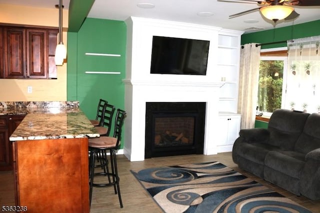 75 Sunrise Ter, Cedar Grove Twp, NJ 07009 - living area featuring a ceiling fan, wood finished floors, and a large fireplace