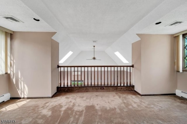 23 Bohnert Pl, Waldwick Boro, NJ 07463 - carpeted empty room featuring a textured ceiling, ceiling fan, baseboards, and vaulted ceiling