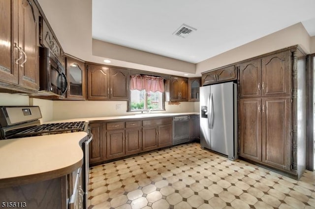 23 Bohnert Pl, Waldwick Boro, NJ 07463 - kitchen featuring stainless steel appliances, light flooring, glass insert cabinets, and light countertops
