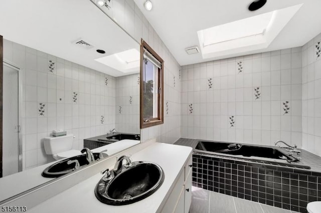 23 Bohnert Pl, Waldwick Boro, NJ 07463 - full bathroom featuring toilet, tile walls, a garden tub, vanity, and tile patterned floors