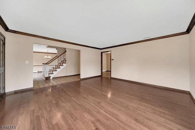 23 Bohnert Pl, Waldwick Boro, NJ 07463 - unfurnished living room featuring wood finished floors, baseboards, stairway, a chandelier, and ornamental molding
