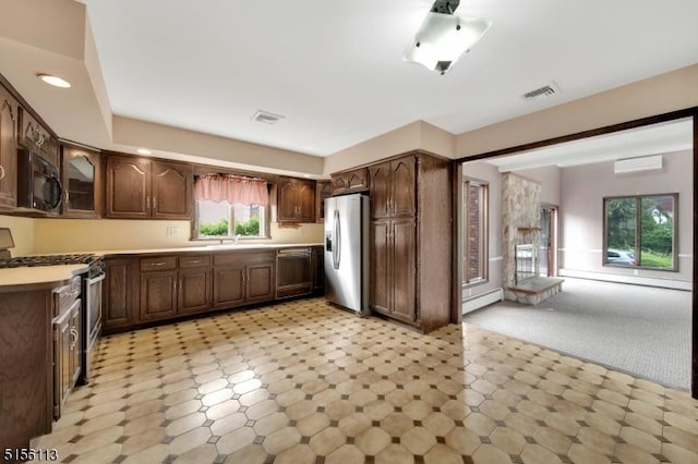 23 Bohnert Pl, Waldwick Boro, NJ 07463 - kitchen featuring appliances with stainless steel finishes, a baseboard heating unit, a sink, light countertops, and a wall mounted AC