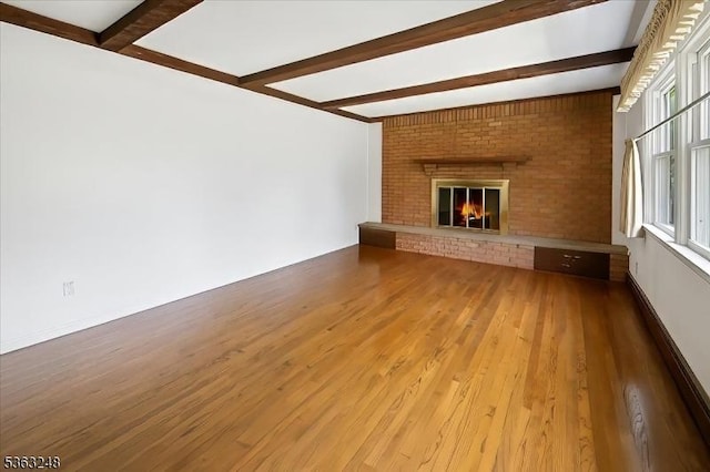 45 Churchill Rd, Cresskill Boro, NJ 07626 - unfurnished living room with beamed ceiling, wood finished floors, a baseboard heating unit, and a brick fireplace