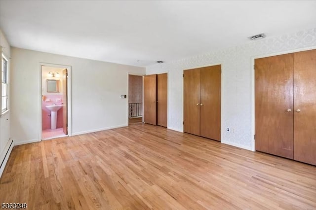 45 Churchill Rd, Cresskill Boro, NJ 07626 - unfurnished bedroom featuring multiple closets, light wood-style flooring, and ensuite bath