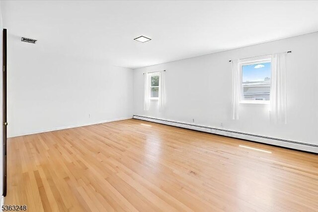 45 Churchill Rd, Cresskill Boro, NJ 07626 - empty room featuring a baseboard radiator and light wood-style floors