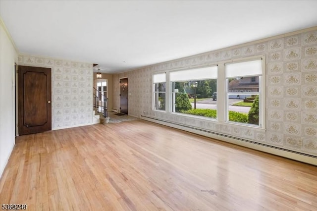 45 Churchill Rd, Cresskill Boro, NJ 07626 - unfurnished living room featuring wallpapered walls, light wood-style flooring, a baseboard radiator, and ornamental molding
