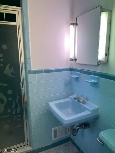 2 Perry Rd, Bloomfield Twp, NJ 07003 - full bath with tile walls, a stall shower, wainscoting, and tile patterned floors