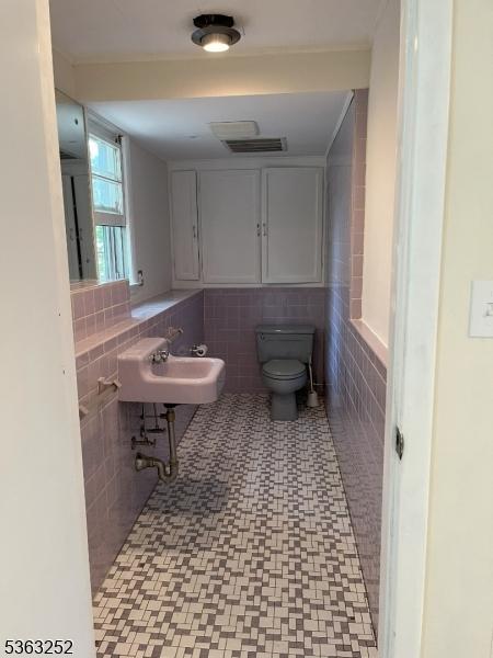 2 Perry Rd, Bloomfield Twp, NJ 07003 - bathroom featuring a sink and tile walls