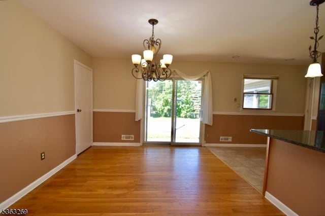 18 Apollo Dr, Jefferson Twp, NJ 07438 - unfurnished dining area featuring a chandelier and light wood-style flooring