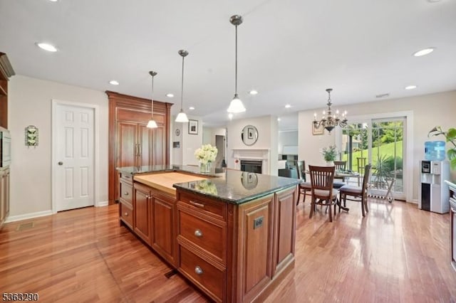 14 Mount Freedom Ave, Randolph Twp, NJ 07869 - kitchen featuring light wood-style flooring, a center island, a fireplace, decorative light fixtures, and recessed lighting